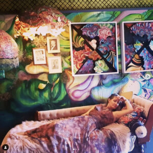 Mural - green leaves and Bec reclining on french style lounge